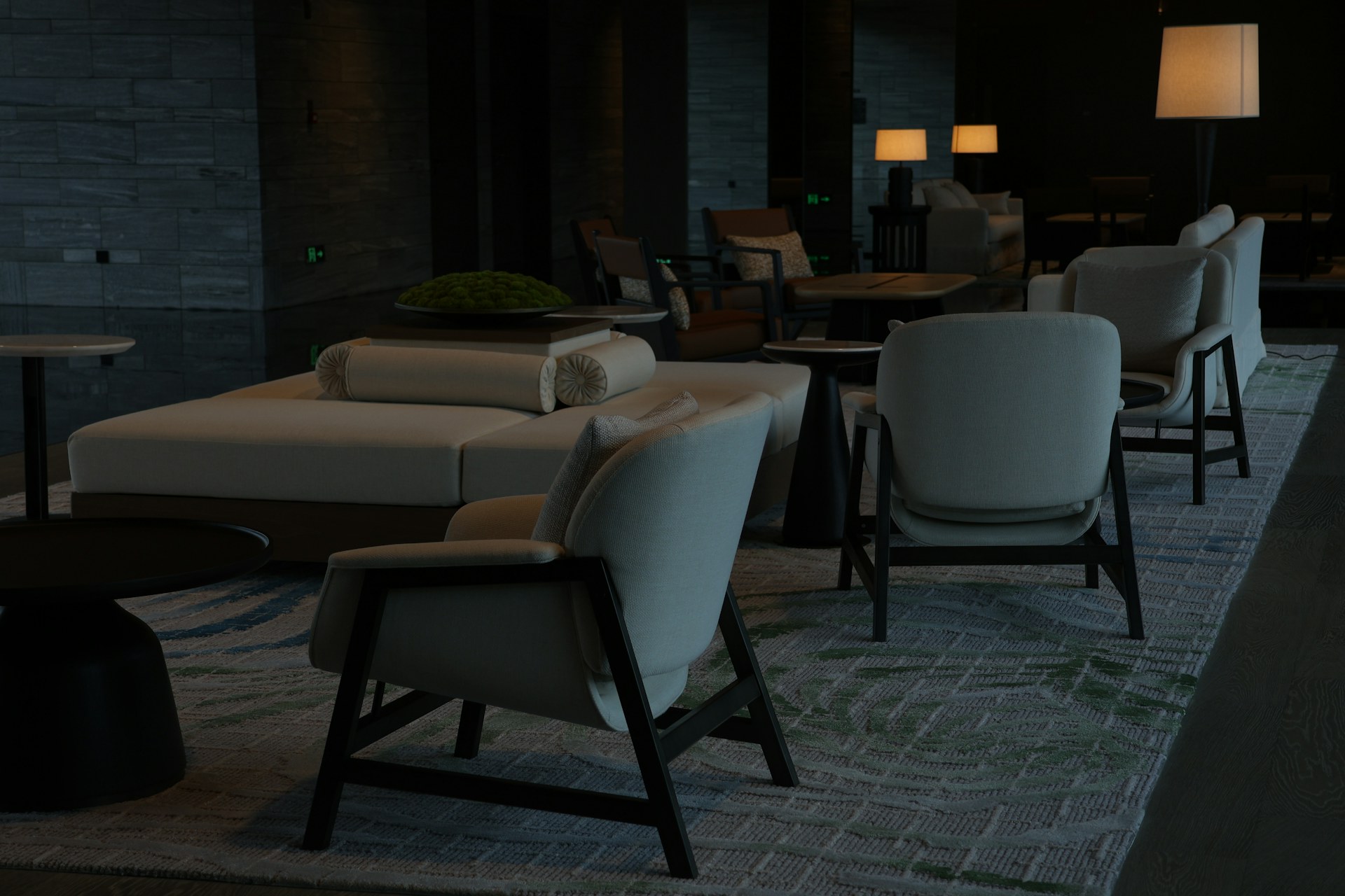 Warmly lit lounge seating in a moody upscale interior — concept imagery