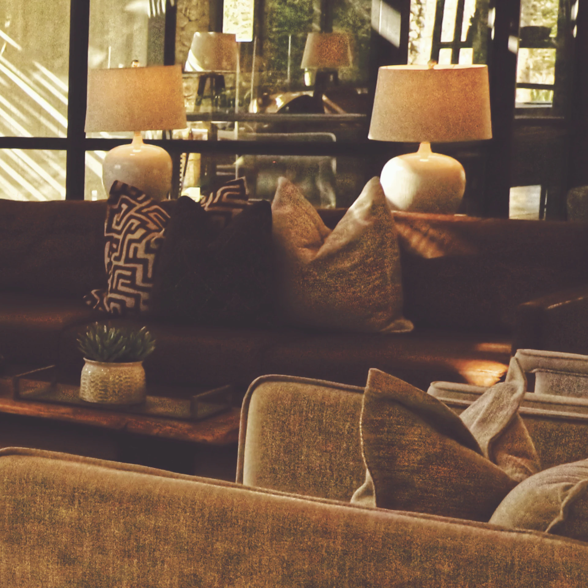 Textured sofa with layered cushions in warm light