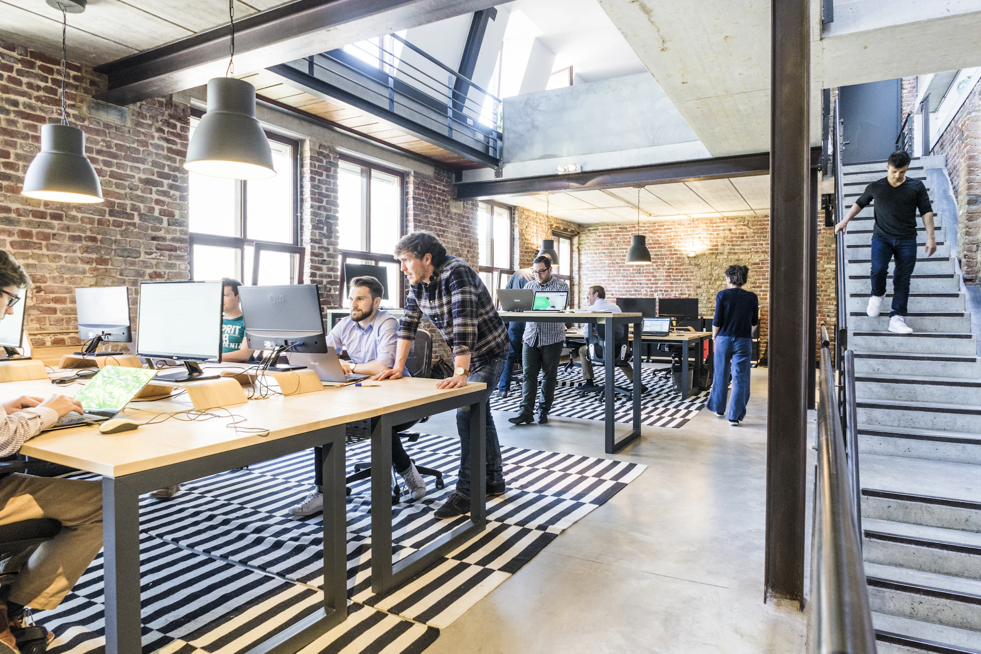 Multi-seater office workstations in a loft-style office