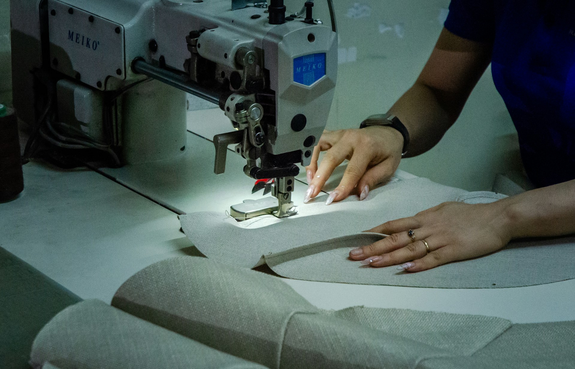 Upholstery in progress, stitching fabric on an industrial machine — concept imagery